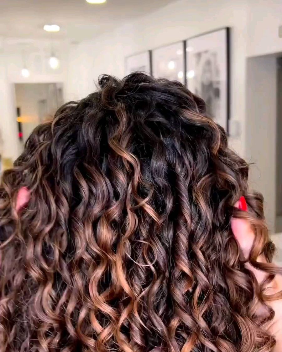 Curly styling with honey highlights