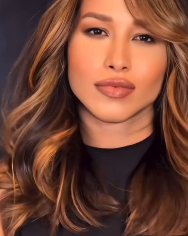 Long, layered waves with golden highlights